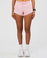 Woman wearing Accelerate 3" Mid-Rise Running Short - Marshmallow | Set:true | Angle:front | Model:Rhiley | Size:S