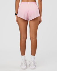 Woman wearing Accelerate 3" Mid-Rise Running Short - Marshmallow | Set:true | Angle:back | Model:Rhiley | Size:S