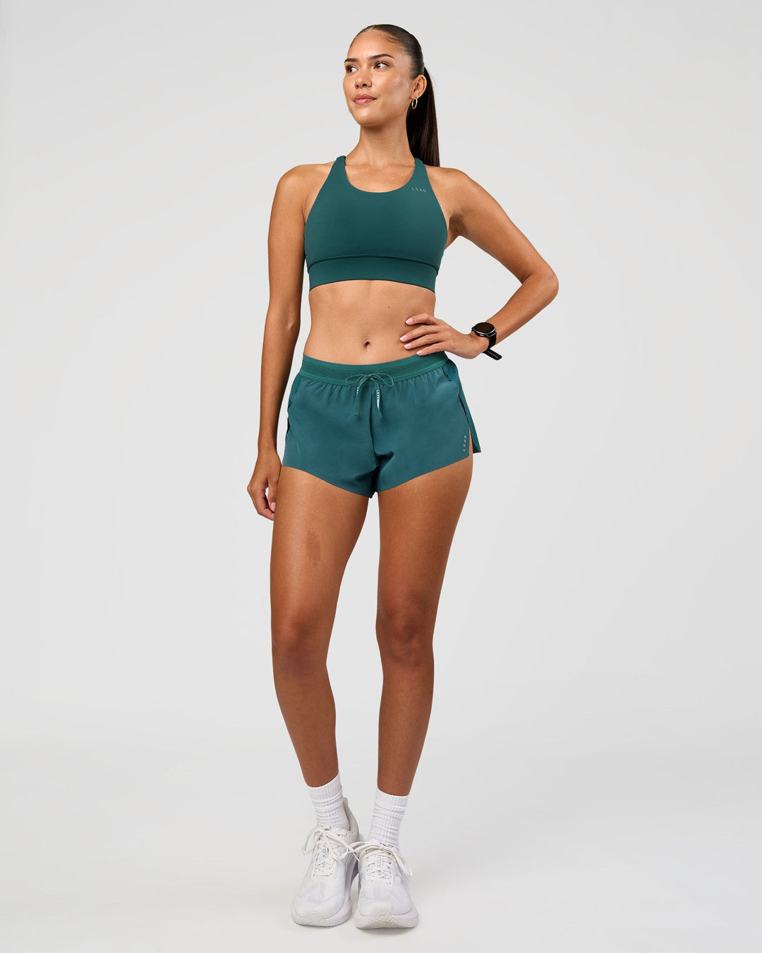 Woman wearing Accelerate 3" Mid-Rise Running Short - Transformative Teal | Model:Rhiley | Size:S