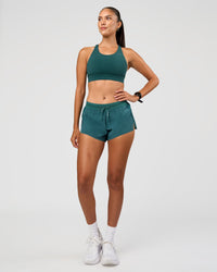 Woman wearing Accelerate 3" Mid-Rise Running Short - Transformative Teal | Model:Rhiley | Size:S