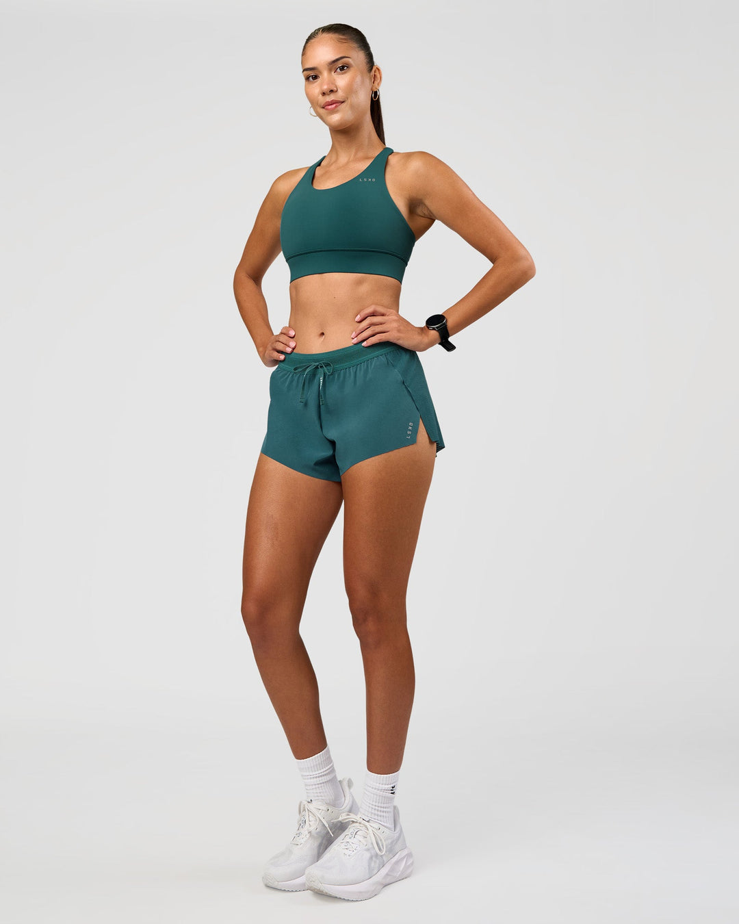 Woman wearing Accelerate 3" Mid-Rise Running Short - Transformative Teal | Model:Rhiley | Size:S