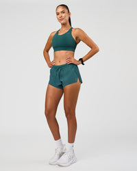 Woman wearing Accelerate 3" Mid-Rise Running Short - Transformative Teal | Model:Rhiley | Size:S