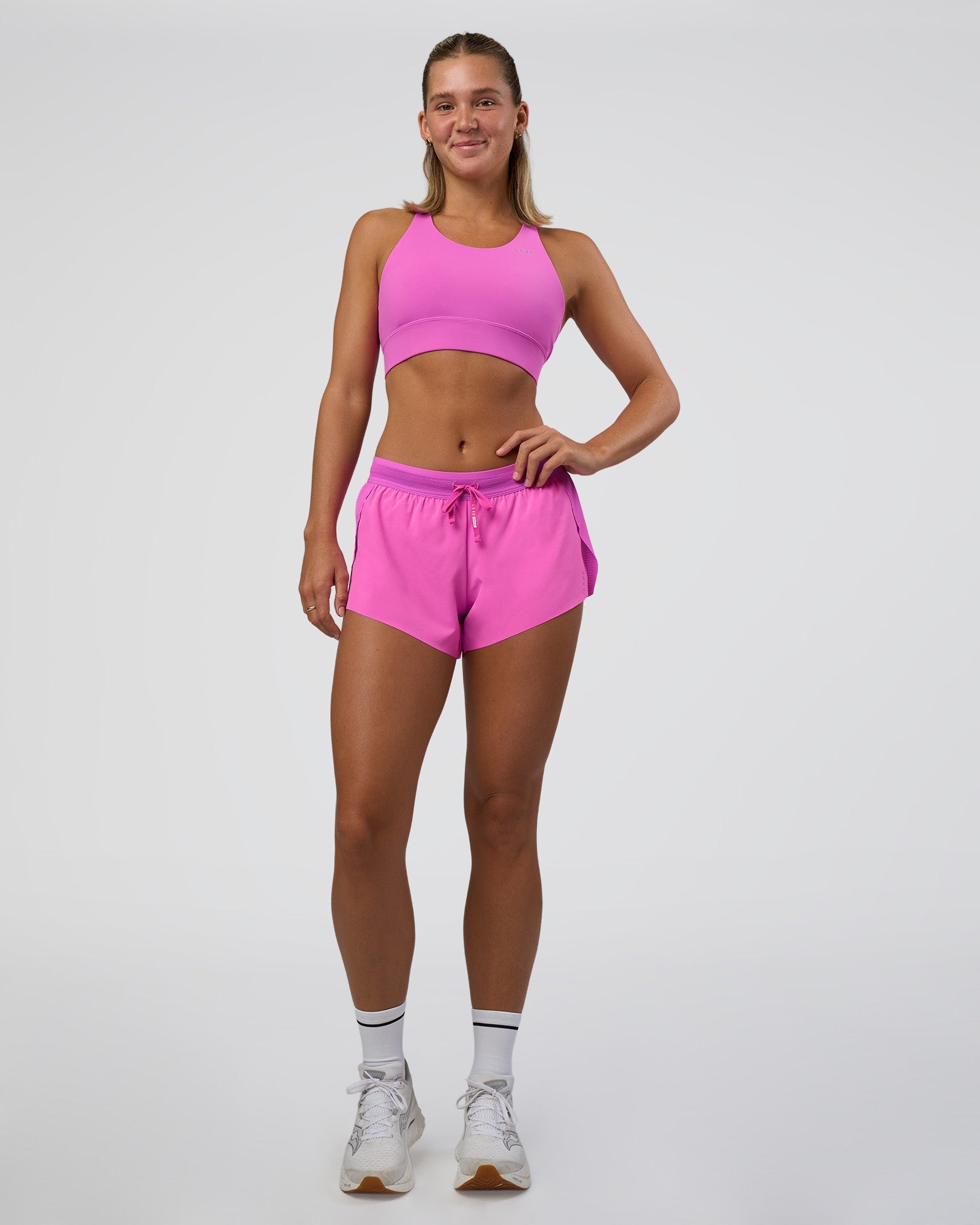 Woman wearing Accelerate 3" Mid-Rise Running Short - Ultra Fuchsia | Model:Amity | Size:S