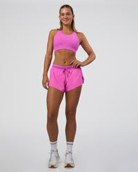 Woman wearing Accelerate 3" Mid-Rise Running Short - Ultra Fuchsia | Model:Amity | Size:S