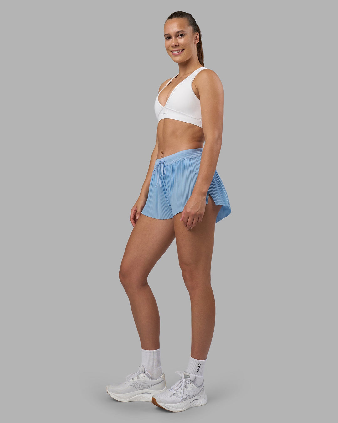 Woman wearing Accelerate 3&quot; Pleated Running Short - Open Air | Model:Charlize | Size:S