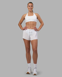 Woman wearing Accelerate 3" Pleated Running Short - White | Model:Charlize | Size:S