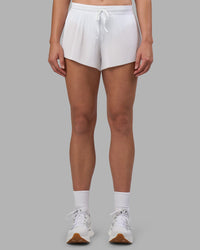 Woman wearing Accelerate 3" Pleated Running Short - White | Model:Charlize | Size:S