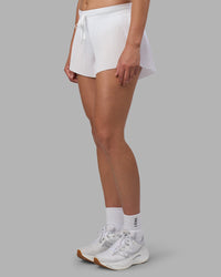 Woman wearing Accelerate 3" Pleated Running Short - White | Model:Charlize | Size:S