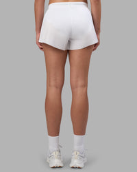 Woman wearing Accelerate 3" Pleated Running Short - White | Model:Charlize | Size:S