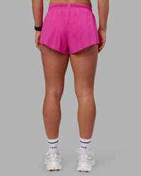 Woman wearing Accelerate 3" Running Short - Ultra Pink | Set:true | Angle:back | Model:Keisha | Size:S
