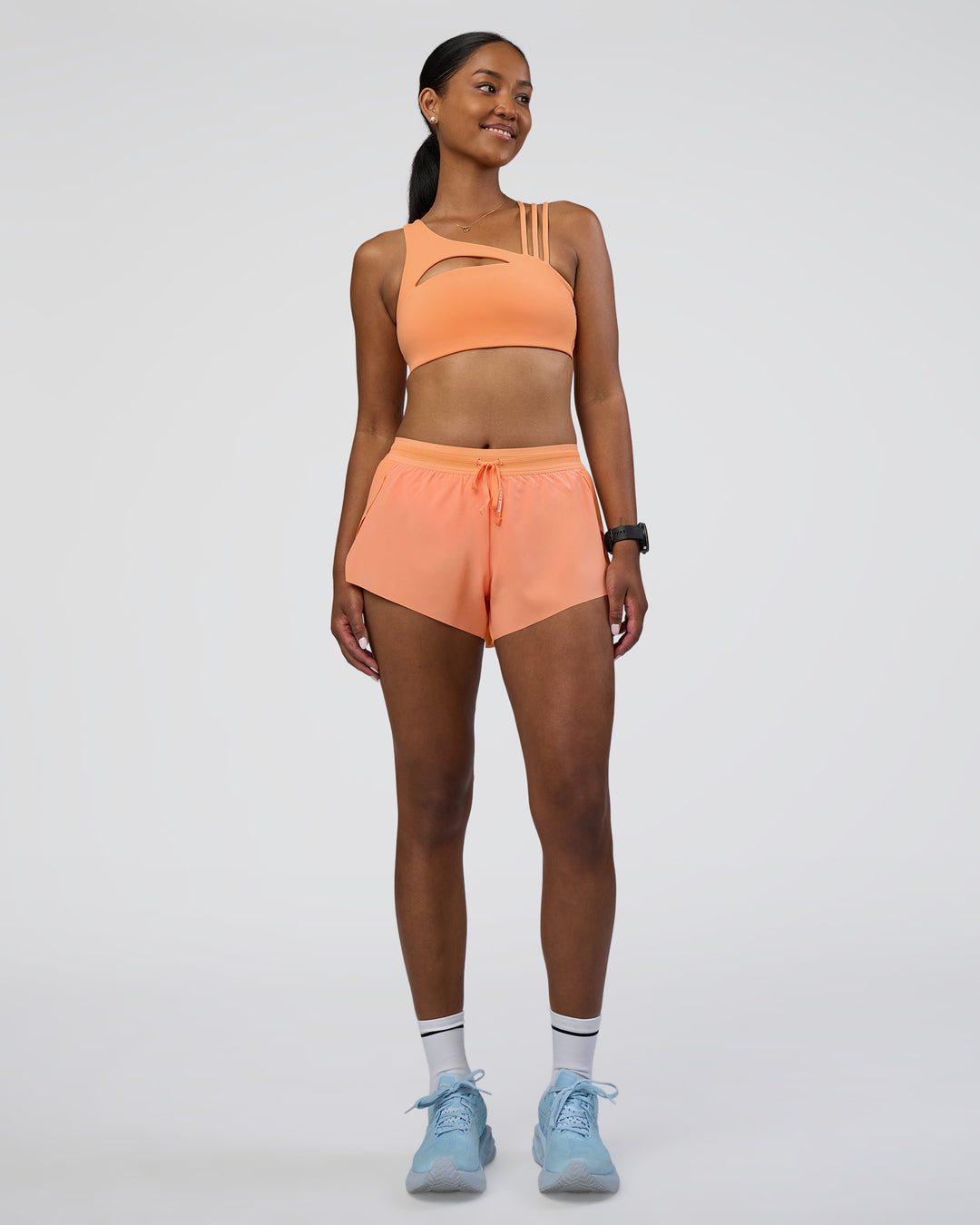 Woman wearing Accelerate 3&quot; Running Short - Cantaloupe | Model:Rica | Size:S
