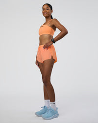 Woman wearing Accelerate 3" Running Short - Cantaloupe | Model:Rica | Size:S