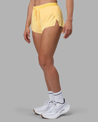 Woman wearing Accelerate 3" Running Short - Lemon | Set:true | Angle:side | Model:Sophie | Size:S