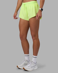 Woman wearing Accelerate 3" Running Short - Lime Glo | Set:true | Angle:side | Model:Hannah | Size:S