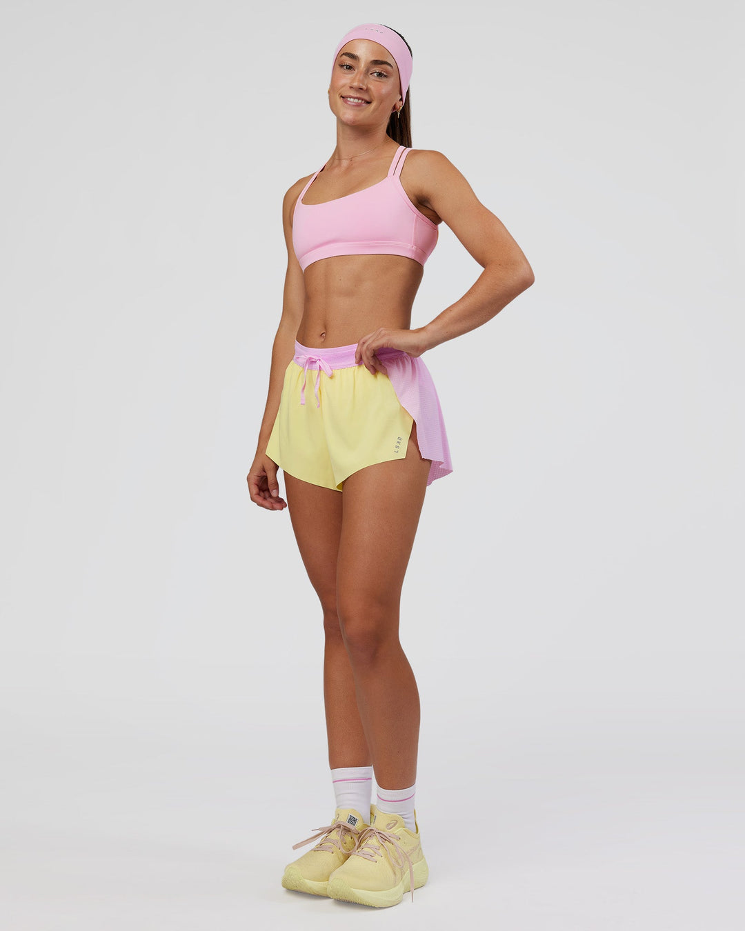 Woman wearing Accelerate 3" Mid-Rise Running Short - Marshmallow-Lemon | Model:Grace | Size:S