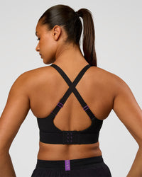 Woman wearing Accelerate Graphic Sports Bra - Black-Radiate | Model:Rosie | Size:S