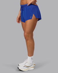 Woman wearing Accelerate 3" Run Short in Power Cobalt | Set:true | Angle:side | Model:Shalem | Size:S