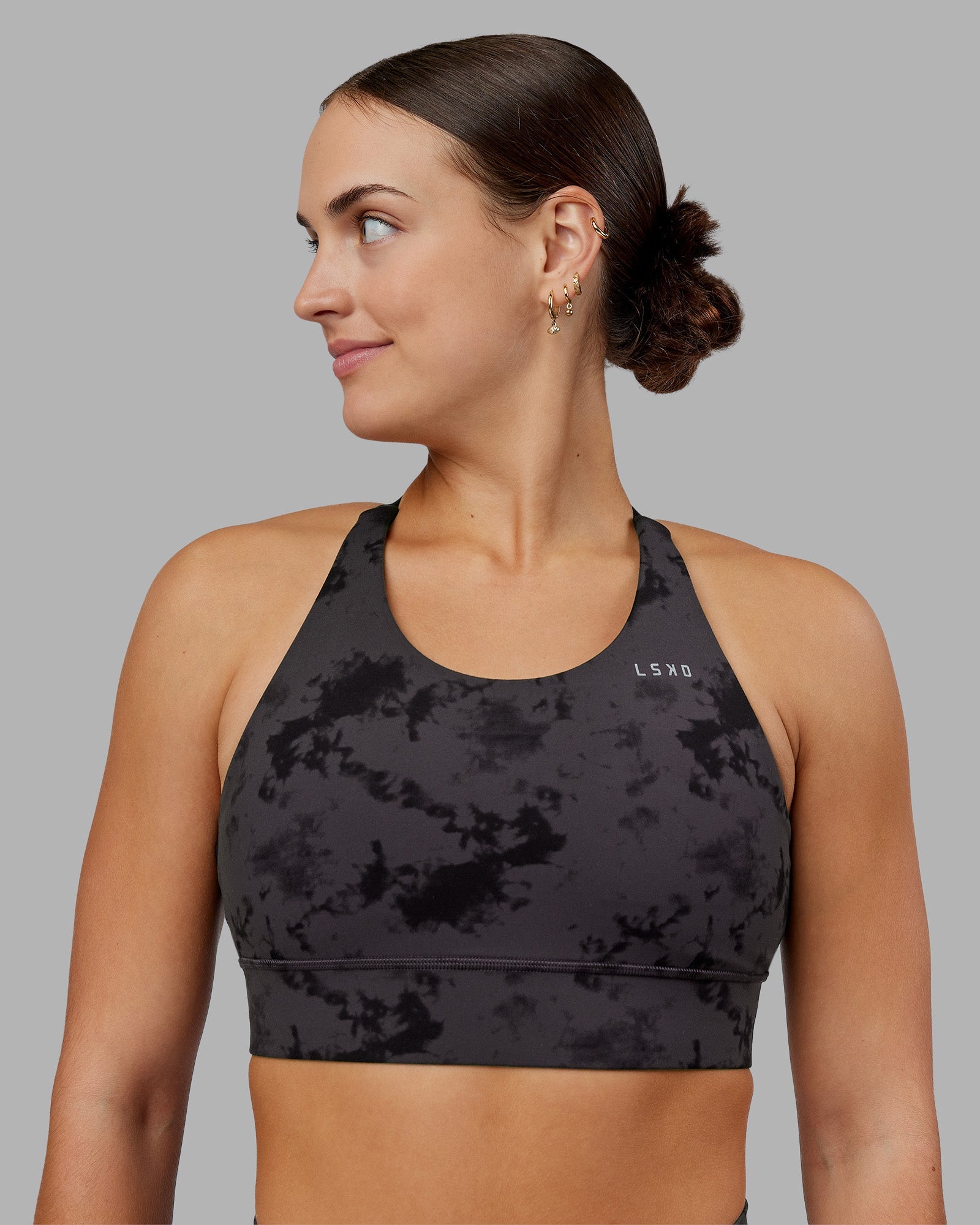 Woman wearing Accelerate Split Strap Sports Bra - Black Tie Dye | Model:Keisha | Size:S