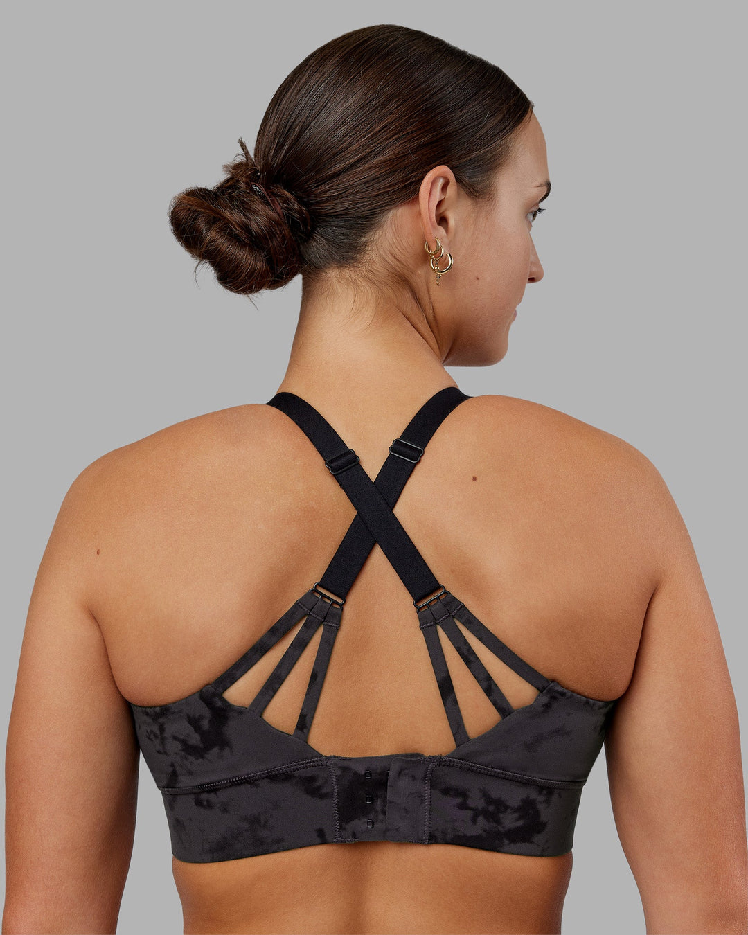 Woman wearing Accelerate Split Strap Sports Bra - Black Tie Dye | Model:Keisha | Size:S