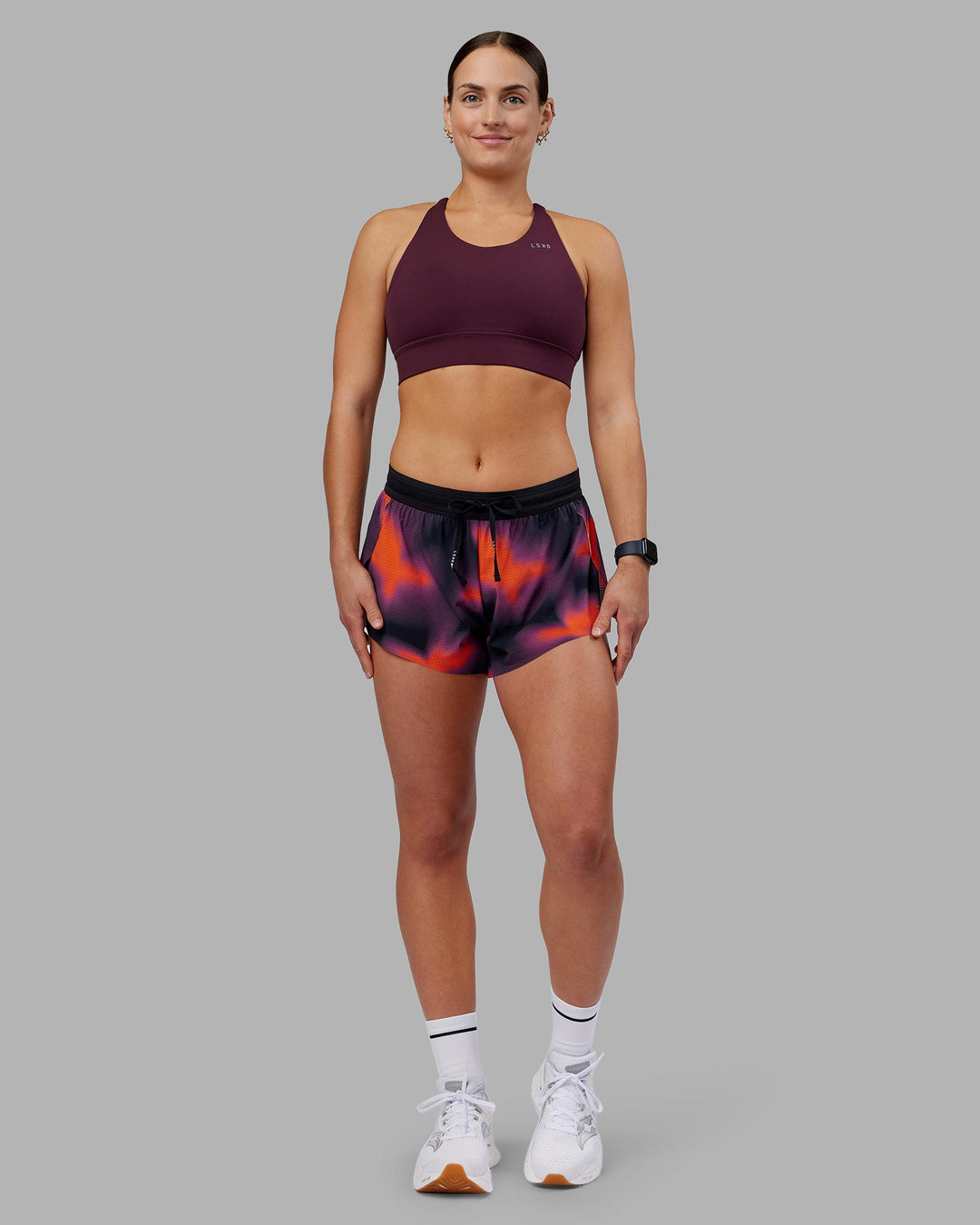 Woman wearing Accelerate Split Strap Sports Bra - Cherry Lacquer | Model:Keisha | Size:S