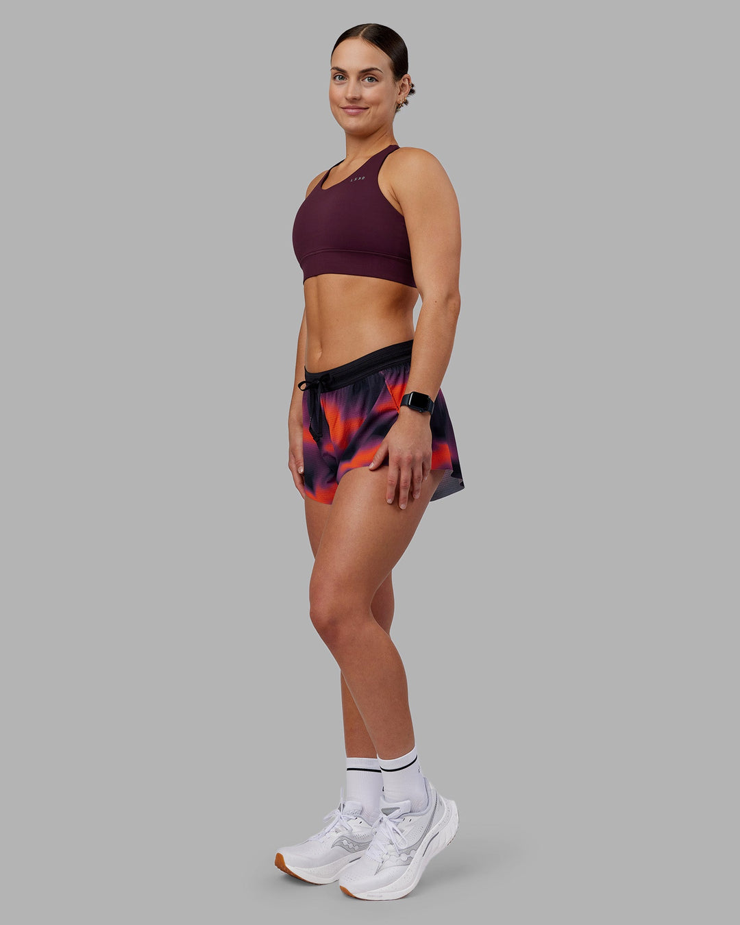 Woman wearing Accelerate Split Strap Sports Bra - Cherry Lacquer | Model:Keisha | Size:S