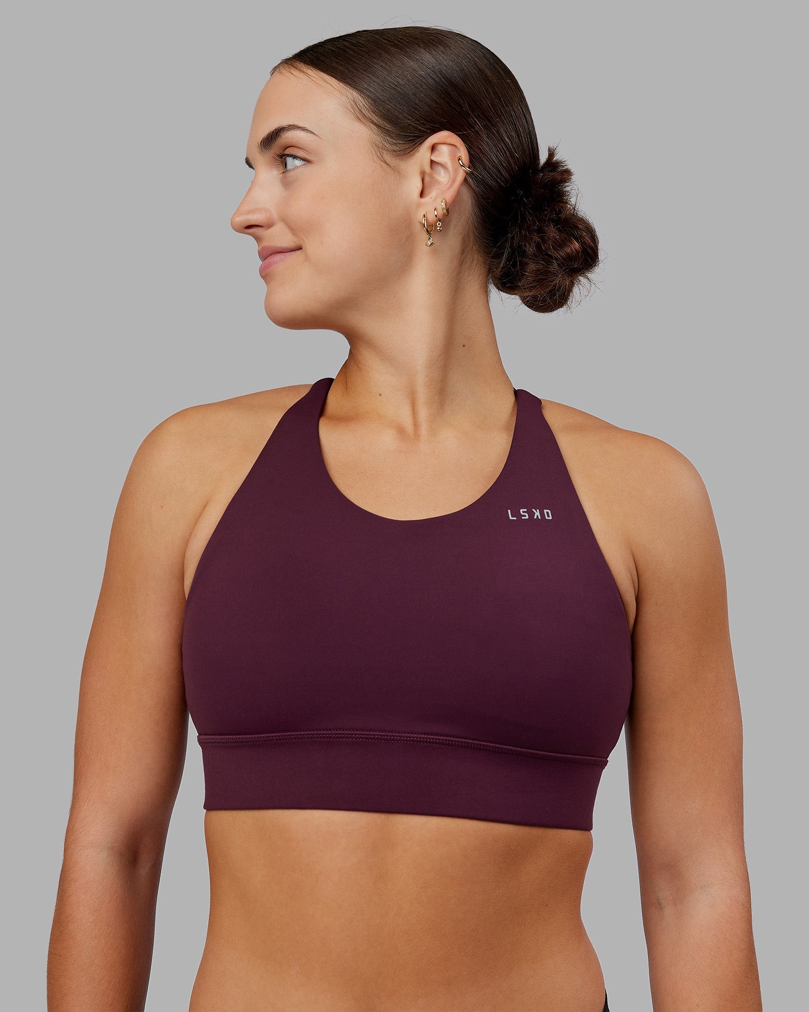 Woman wearing Accelerate Split Strap Sports Bra - Cherry Lacquer | Model:Keisha | Size:S