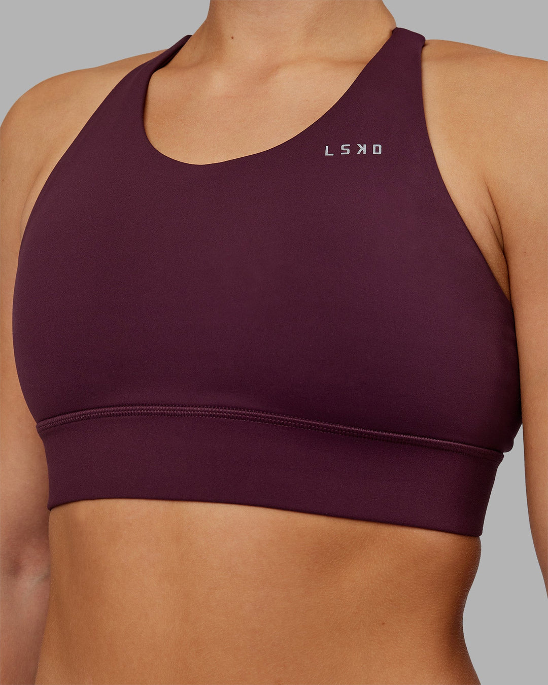 Woman wearing Accelerate Split Strap Sports Bra - Cherry Lacquer | Model:Keisha | Size:S