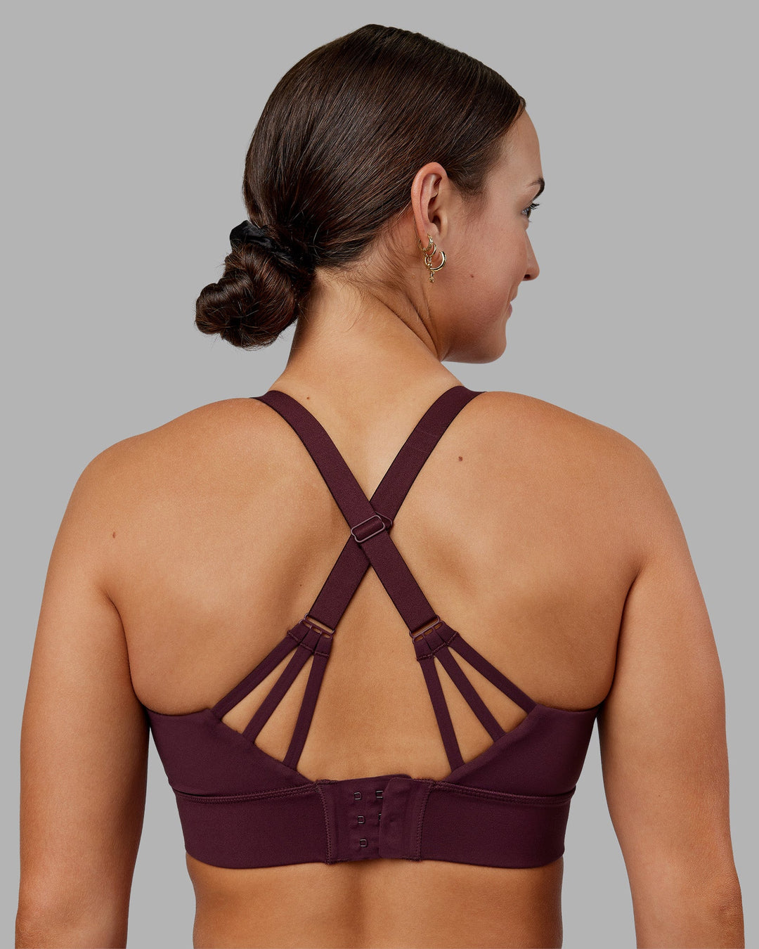 Woman wearing Accelerate Split Strap Sports Bra - Cherry Lacquer | Model:Keisha | Size:S