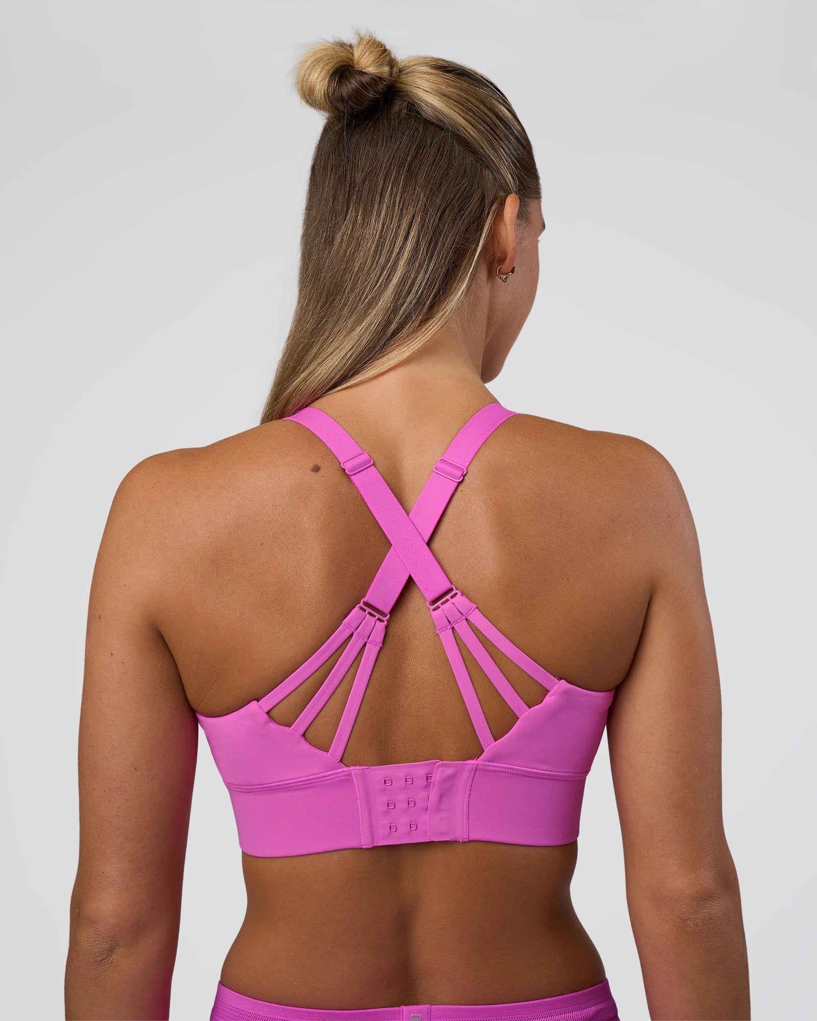 Woman wearing Accelerate Split Strap Sports Bra - Ultra Fuchsia | Model:Amity | Size:S