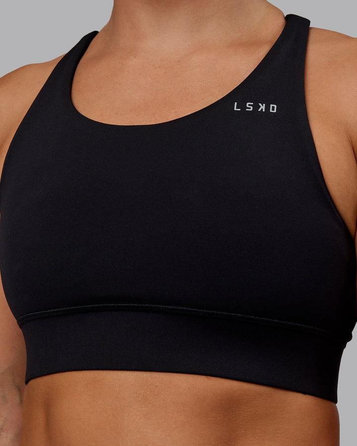 Woman wearing Accelerate Sports Bra in Black | Size:S
