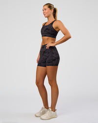 Woman wearing Accelerate Sports Bra - Black Tie Dye | Model:Amity | Size:S