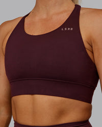 Woman wearing Accelerate Sports Bra - Cherry Lacquer | Set:true | Angle:closeup | Model:Hannah | Size:S