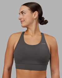 Woman wearing Accelerate Sports Bra - Dark Storm | Set:true | Angle:front | Model:Keisha | Size:S