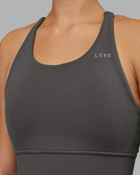 Woman wearing Accelerate Sports Bra - Dark Storm | Set:true | Angle:closeup | Model:Keisha | Size:S