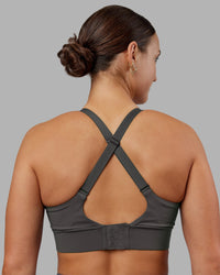 Woman wearing Accelerate Sports Bra - Dark Storm | Set:true | Angle:back | Model:Keisha | Size:S