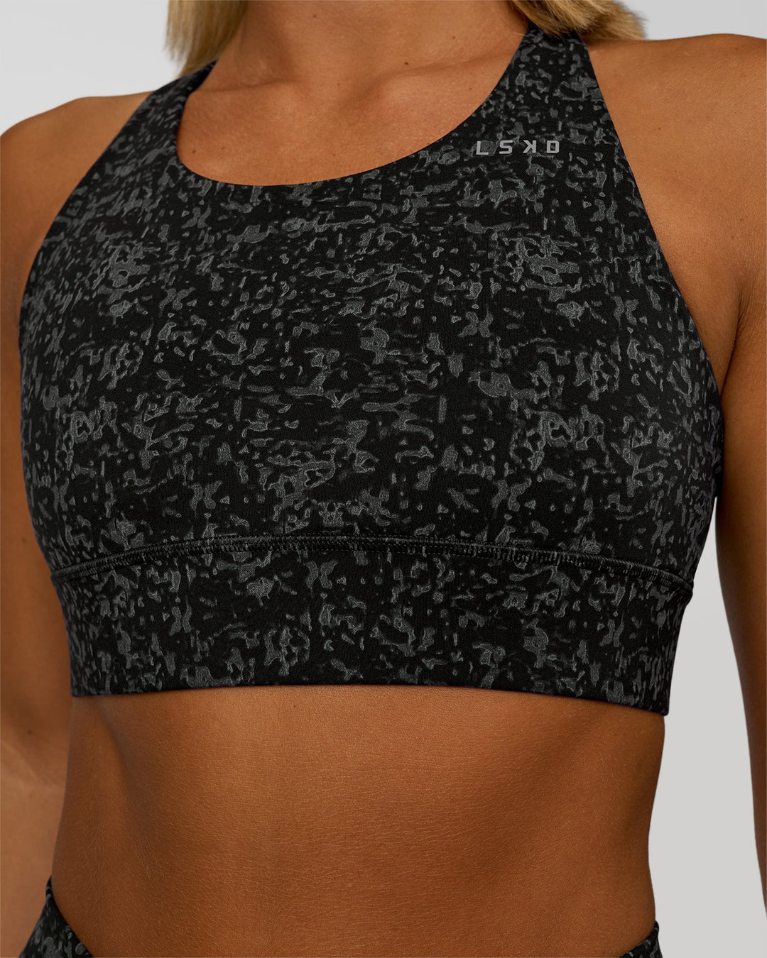 Woman wearing Accelerate Sports Bra - Energy Print Black | Model:Amity | Size:S