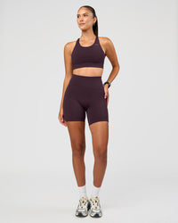 Woman wearing Accelerate Sports Bra - Midnight Plum | Model:Rhiley | Size:S