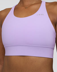 Woman wearing Accelerate Sports Bra - Pale Lilac | Set:true | Angle:closeup | Model:Rica | Size:S