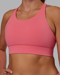 Woman wearing Accelerate Sports Bra in Pink Lemonade | Model:Phoebe | Size:S