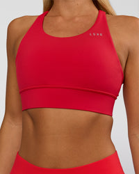 Woman wearing Accelerate Sports Bra - Scarlet | Set:true | Angle:closeup | Model:Amity | Size:S