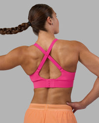 Woman wearing Accelerate Sports Bra - Ultra Pink | Model:Hannah | Size:S