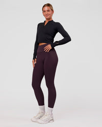 Woman wearing AeroFLX+ Long Sleeve Skimmer Half Zip - Black Marl | Model:Amity | Size:S