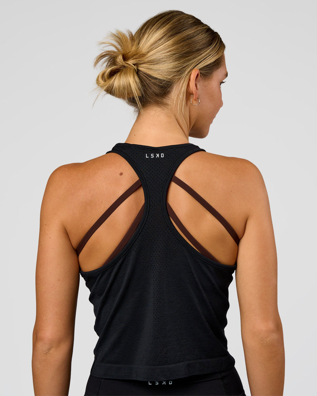 Woman wearing AeroFLX+ Seamless Flow Skimmer Tank - Black Marl | Model:Amity | Size:S