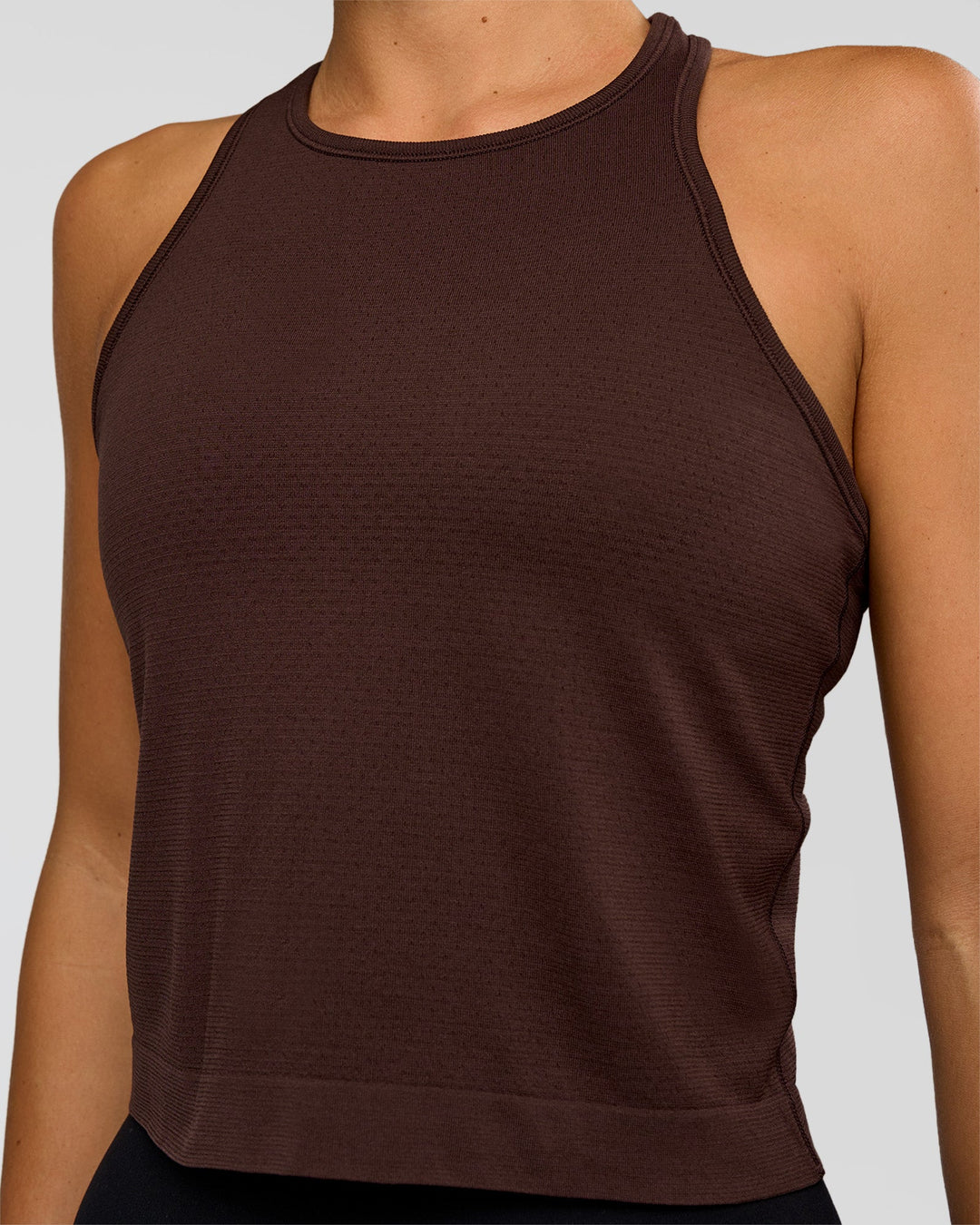 Woman wearing AeroFLX+ Seamless Flow Skimmer Tank - Hot Chocolate/Hot Chocolate | Model:Amity | Size:S