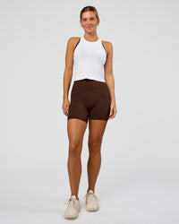 Woman wearing AeroFLX+ Seamless Flow Skimmer Tank - White/White | Model:Amity | Size:S