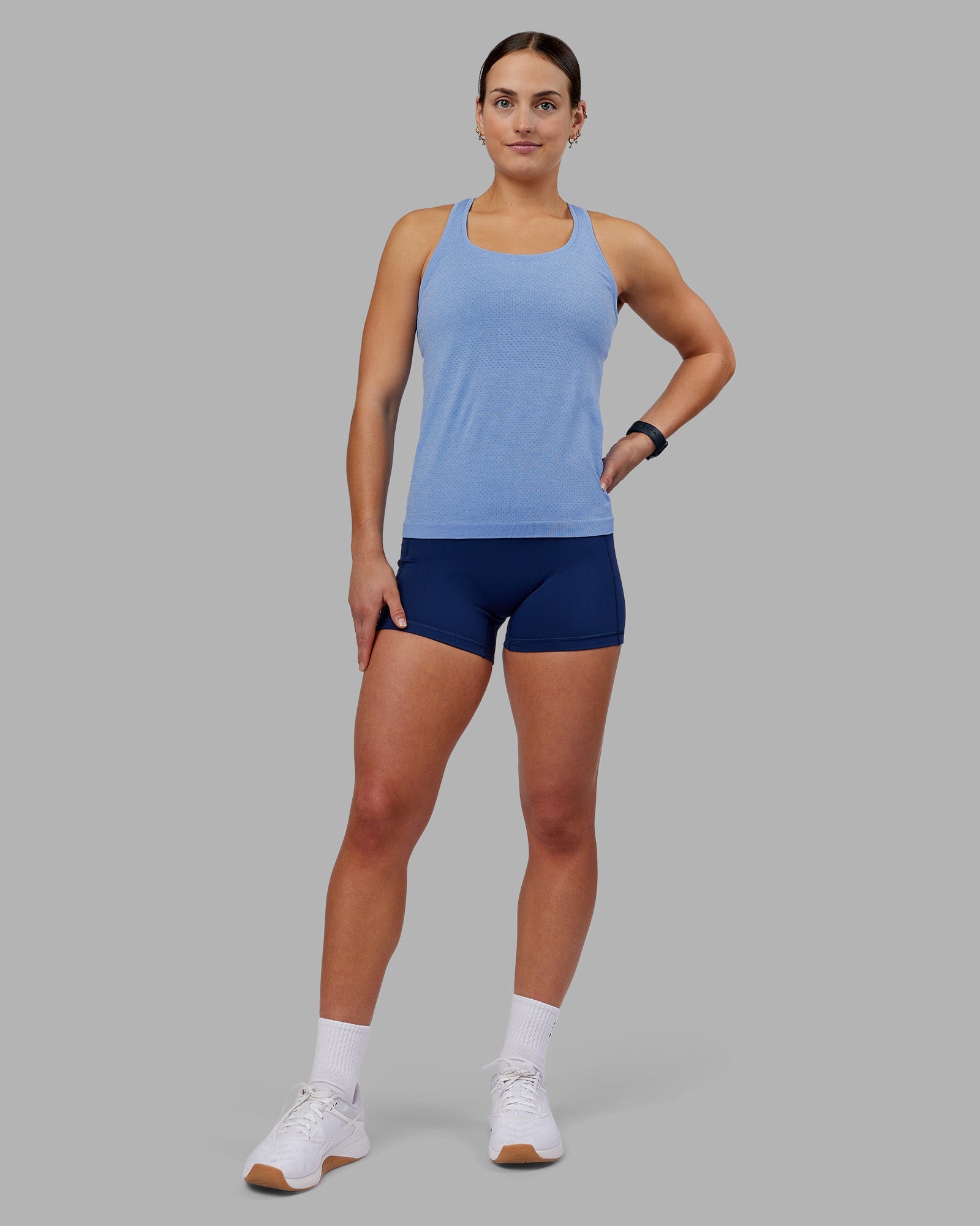Woman wearing AeroFLX+ Seamless Tank - Cornflower Blue Marl | Model:Keisha | Size:S
