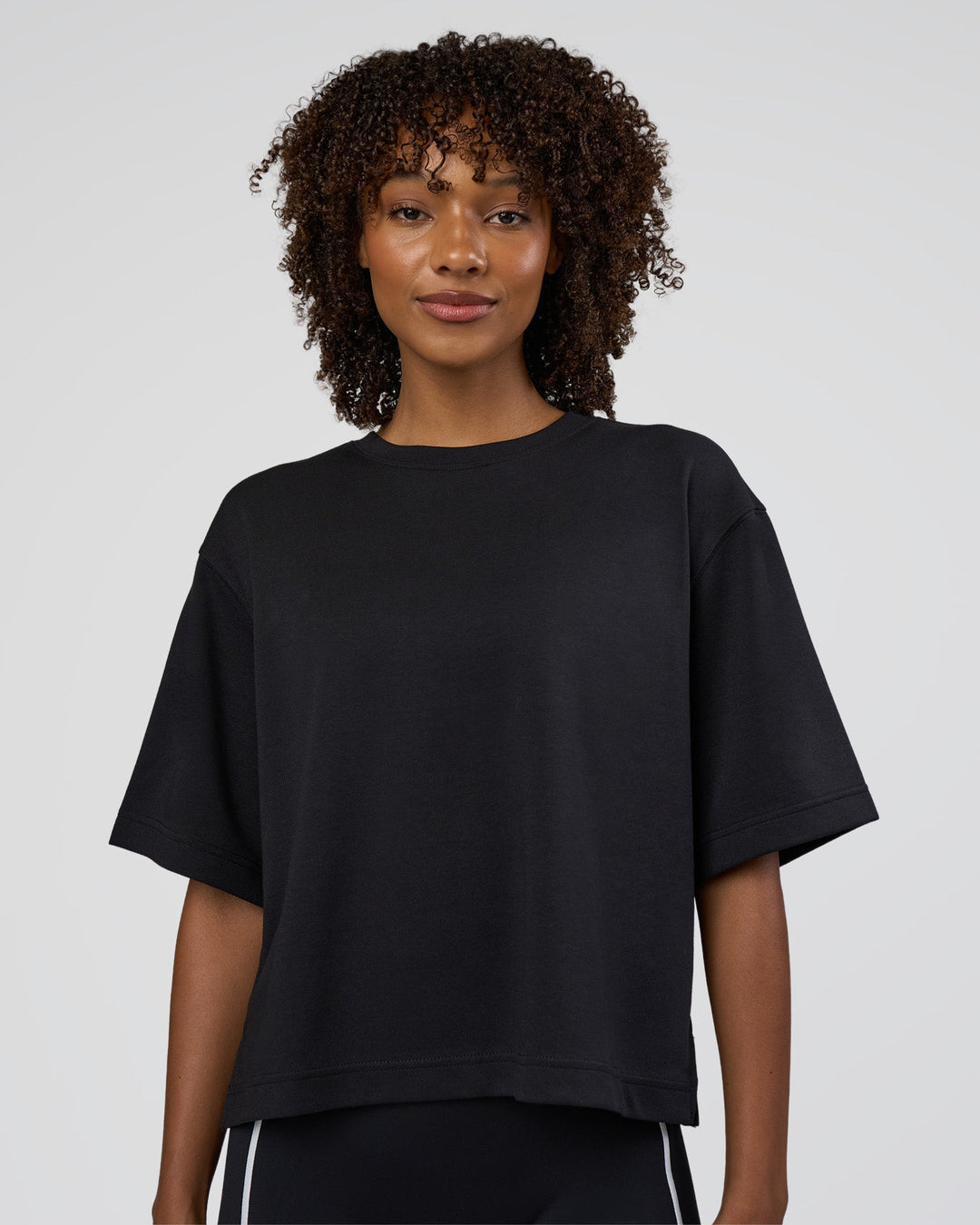 Woman wearing AfterDark ZeroCrease Cropped Tee - Black | Model:Tomi | Size:S - view 1