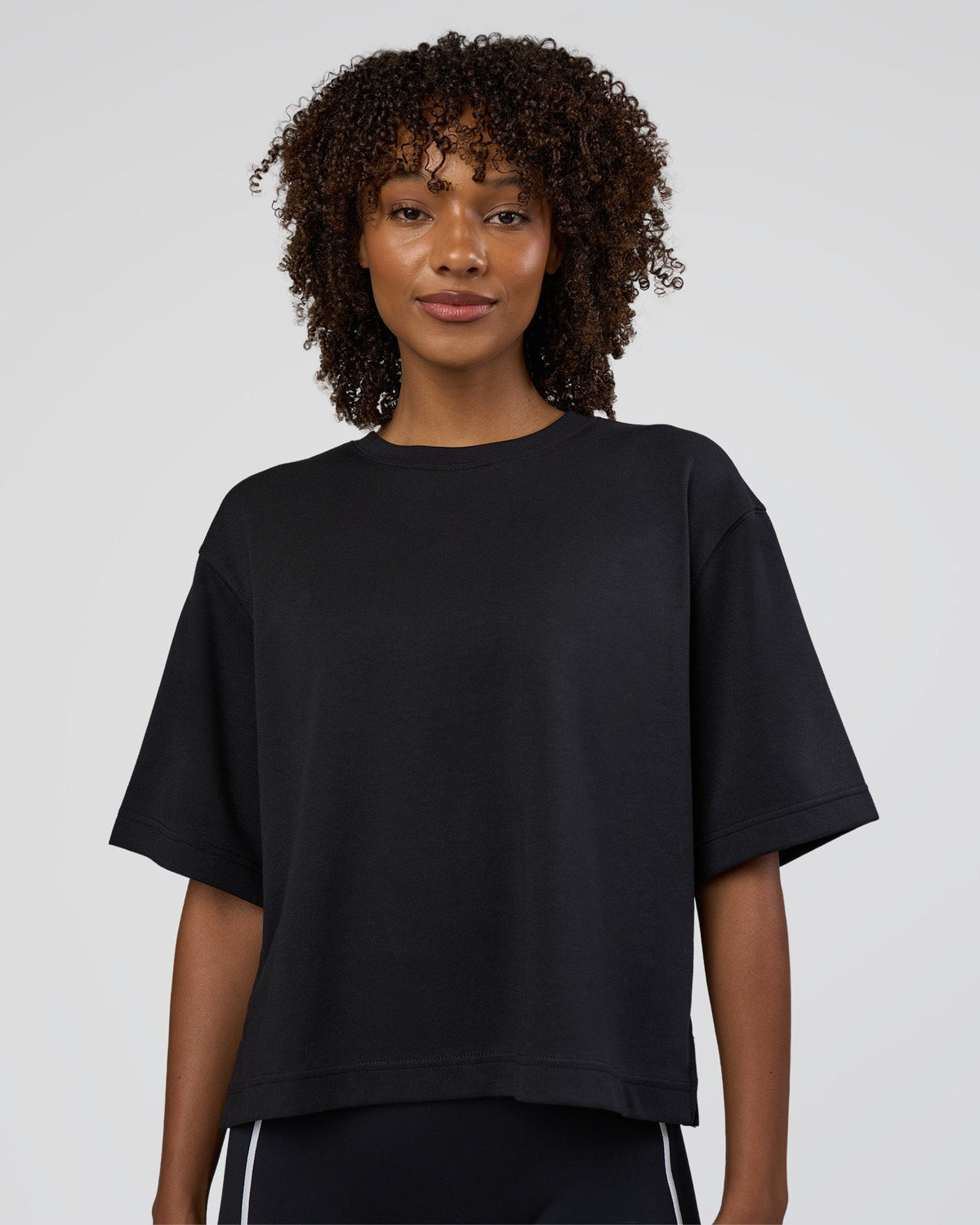 Woman wearing AfterDark ZeroCrease Cropped Tee - Black | Model:Tomi | Size:S - view 1