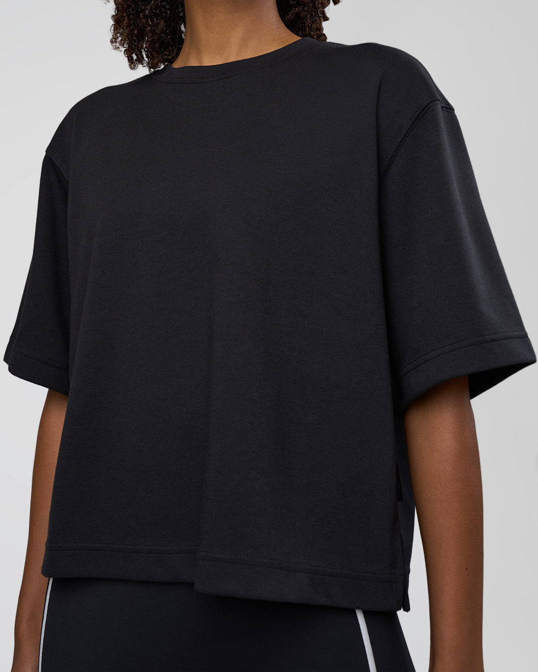 Woman wearing AfterDark ZeroCrease Cropped Tee - Black | Model:Tomi | Size:S