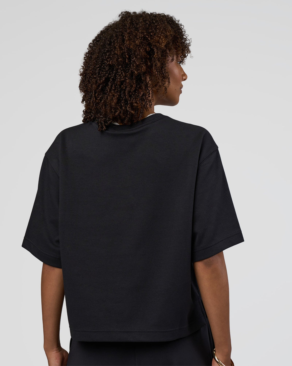 Woman wearing AfterDark ZeroCrease Cropped Tee - Black | Model:Tomi | Size:S - view 2